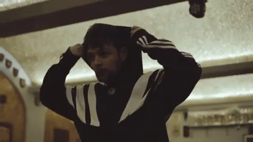 A Man Wearing A Black And White Adidas Sweatshirt GIF
