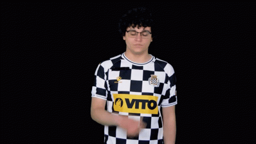 A Man Wearing A Black And White Checkered Shirt That Says Vito GIF