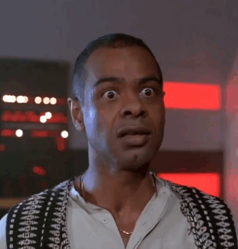 A Man Wearing A Black And White Vest Looks Surprised GIF