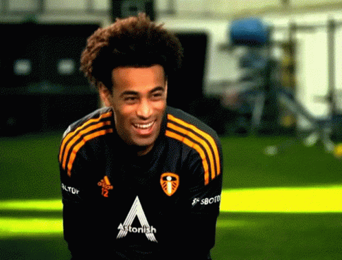A Man Wearing A Black And Yellow Adidas Shirt With The Letter A On The Front GIF
