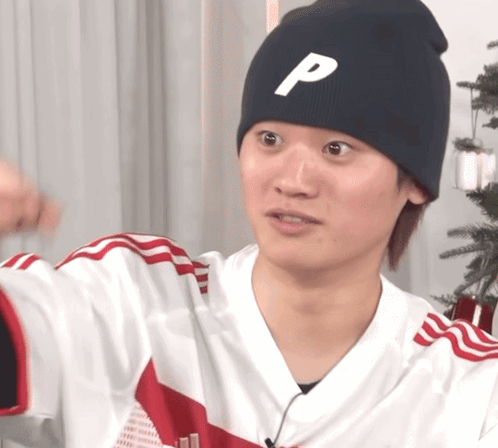 A Man Wearing A Black Beanie With The Letter P On It GIF