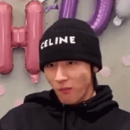 A Man Wearing A Black Celine Beanie Is Making A Funny Face . GIF