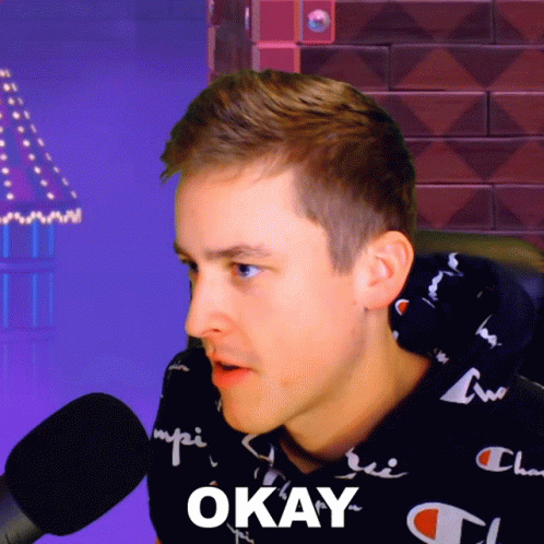 A Man Wearing A Black Champion Sweatshirt Says Okay GIF