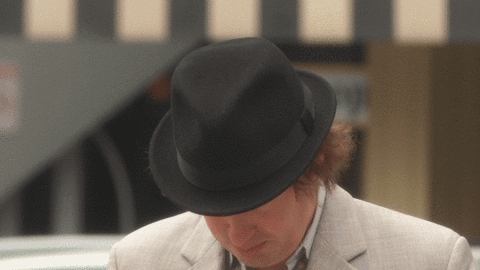 A Man Wearing A Black Fedora And A White Jacket GIF