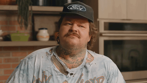 A Man Wearing A Black Ford Hat And A Dirty Shirt GIF