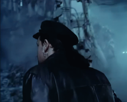 a man wearing a black hat and a black jacket