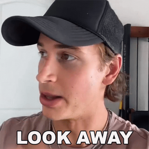 A Man Wearing A Black Hat And A Necklace Says Look Away GIF