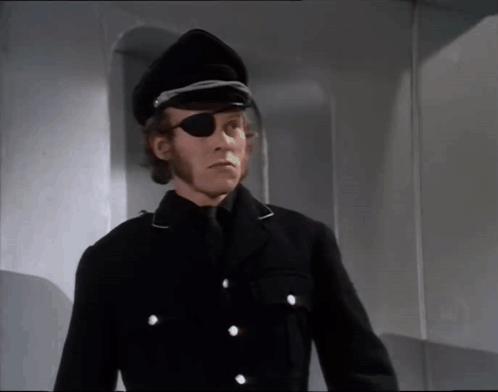 A Man Wearing A Black Hat And Eye Patch GIF