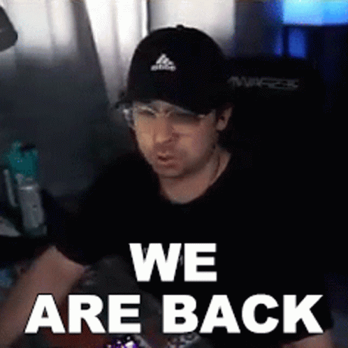 A Man Wearing A Black Hat And Glasses Says We Are Back GIF