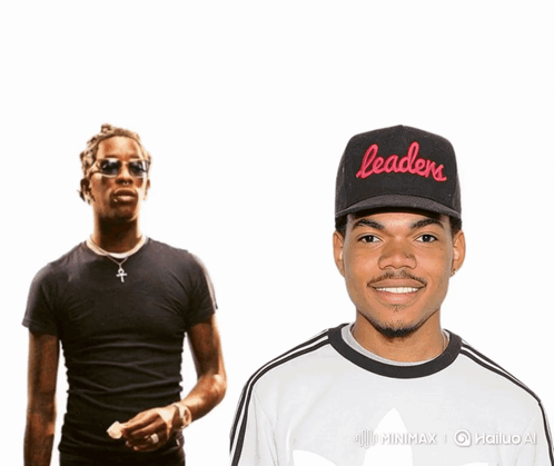 A Man Wearing A Black Hat That Says Leaders Stands Next To Another Man GIF