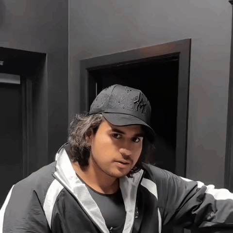 A Man Wearing A Black Hat That Says Ny GIF