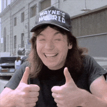 A Man Wearing A Black Hat That Says Wayne 'S World Gives Two Thumbs Up GIF