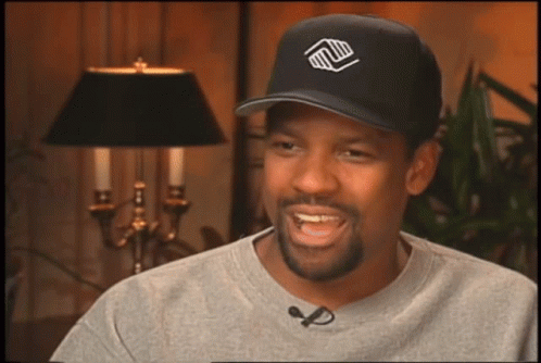 A Man Wearing A Black Hat With A Logo On It GIF