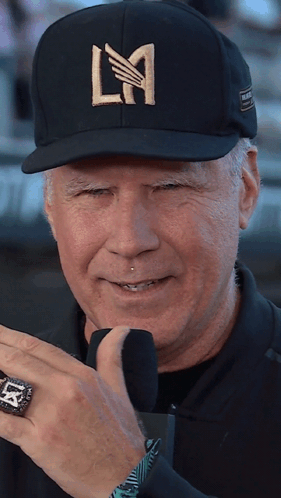 A Man Wearing A Black Hat With La Written On It GIF