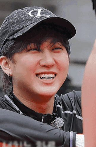 A Man Wearing A Black Hat With The Letter L On It Smiles GIF