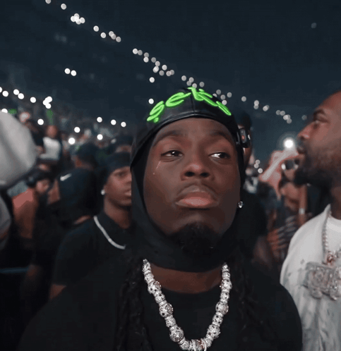 A Man Wearing A Black Hat With The Word Sex Written On It GIF