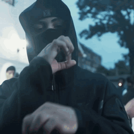 A Man Wearing A Black Hooded Jacket And A Ny Hat GIF