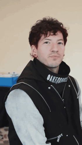 A Man Wearing A Black Hoodie That Says Daremore On It GIF