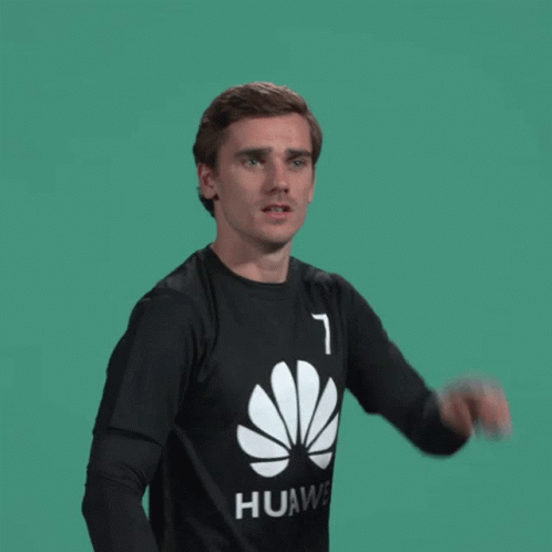 A Man Wearing A Black Huawei Shirt Is Pointing GIF