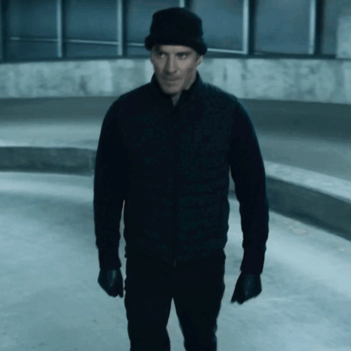 A Man Wearing A Black Jacket And A Black Hat GIF