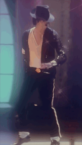 A Man Wearing A Black Jacket And A White Shirt Is Dancing GIF
