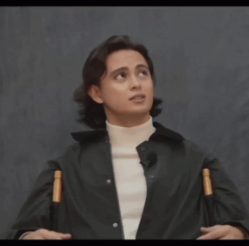 A Man Wearing A Black Jacket And A White Turtleneck Looks Up At The Sky GIF