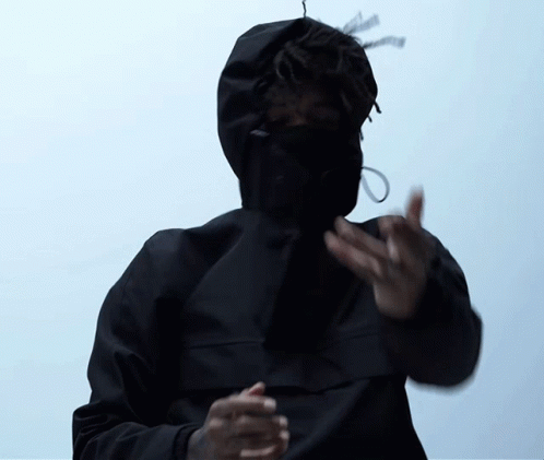 A Man Wearing A Black Jacket With A Hood On His Face GIF