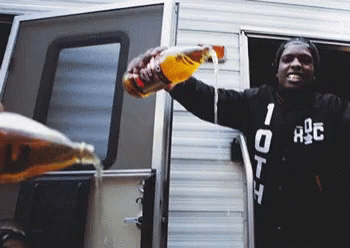 A Man Wearing A Black Jacket With The Number 10 On It Pours A Drink From A Bottle GIF