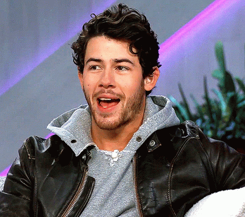 A Man Wearing A Black Leather Jacket And A Grey Sweatshirt GIF