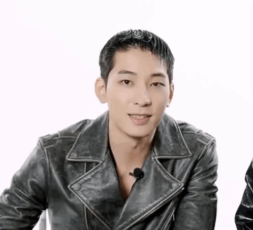 A Man Wearing A Black Leather Jacket Is Smiling GIF