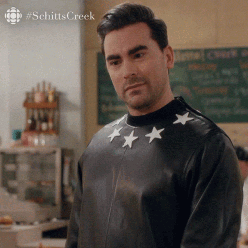 A Man Wearing A Black Leather Jacket With White Stars On The Sleeves GIF