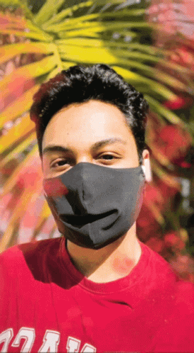 A Man Wearing A Black Mask And A Red Shirt That Says ' Uc San Diego ' On It GIF