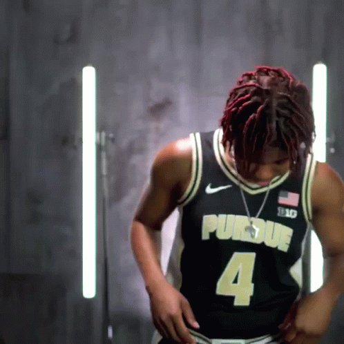 A Man Wearing A Black Purdue Jersey With The Number 4 GIF
