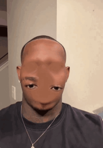 A Man Wearing A Black Shirt And A Necklace Has A Strange Face GIF