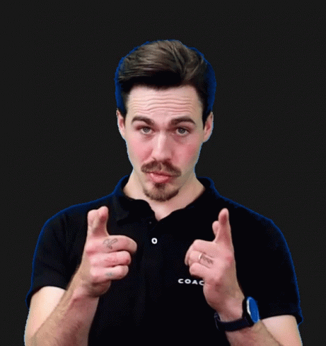 A Man Wearing A Black Shirt And A Watch Giving A Thumbs Up GIF