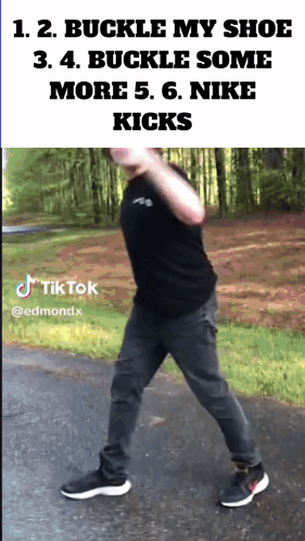 A Man Wearing A Black Shirt And Gray Pants Is Walking Down A Street With A Tiktok Watermark GIF