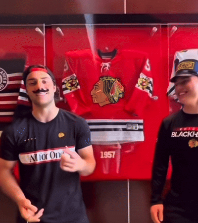 A Man Wearing A Black Shirt That Says All For One Is Standing Next To Another Man GIF
