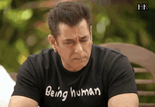A Man Wearing A Black Shirt That Says Being Human On It GIF