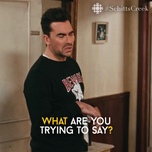 A Man Wearing A Black Shirt That Says Beware Is Asking What Are You Trying To Say GIF