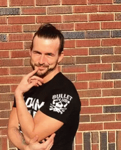A Man Wearing A Black Shirt That Says Bullet Club GIF