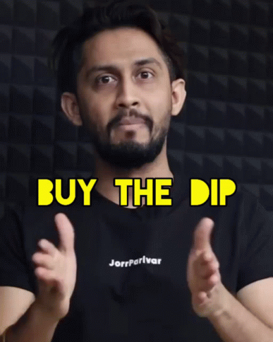 A Man Wearing A Black Shirt That Says Buy The Dip On It GIF