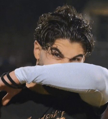 A Man Wearing A Black Shirt That Says ' Dsvih ' On It GIF