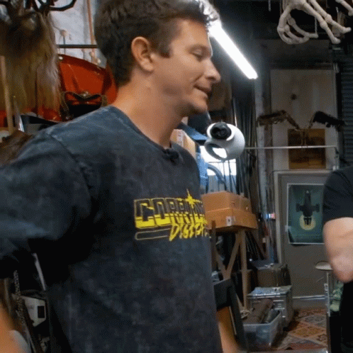 A Man Wearing A Black Shirt That Says Gnarly Disco On It GIF