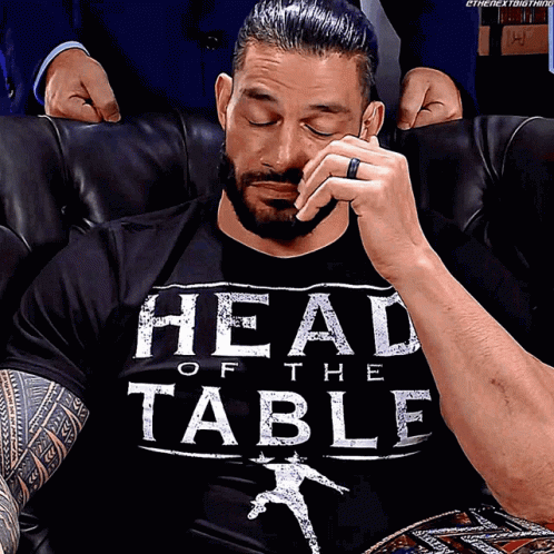 A Man Wearing A Black Shirt That Says Head Of The Table On It GIF
