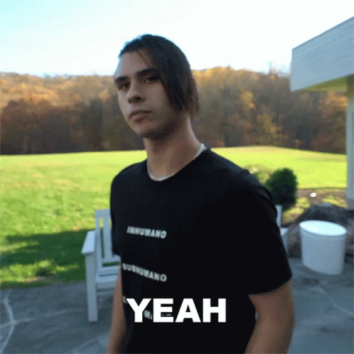 A Man Wearing A Black Shirt That Says Inhumano On It GIF