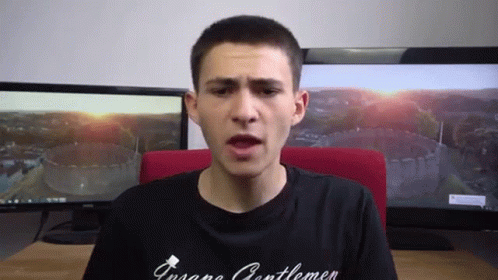 a man wearing a black shirt that says ' insane gentlemen '