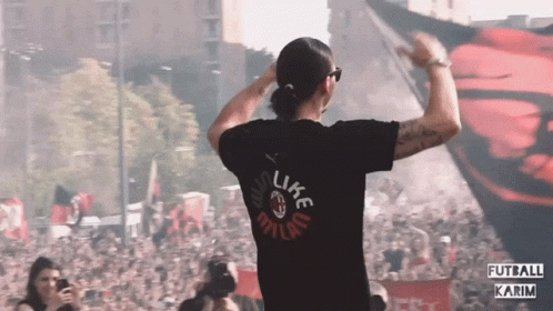 a man wearing a black shirt that says like milan