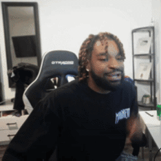 A Man Wearing A Black Shirt That Says Monkey Is Sitting In A Gaming Chair GIF