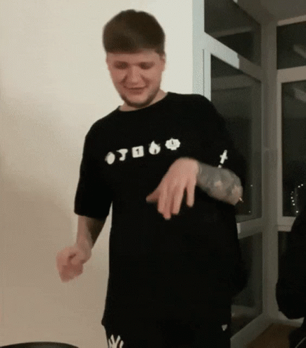 A Man Wearing A Black Shirt That Says ' Otoko ' On It Is Dancing GIF