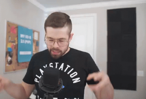 A Man Wearing A Black Shirt That Says Play Station GIF